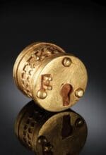 Das goldene Miniatur Dosenschloss ist keliner als eine Ein-Euro-Münze - Foto LWL /Stefan Brentführer